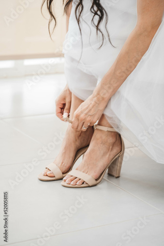 Cropped view of female ballet leg sitting with legs in room