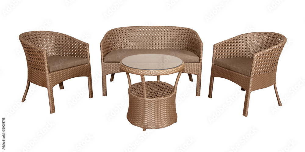 Set of wicker rattan furniture for the garden or terrace. Comfortable sofa and two armchairs with soft pillows and a coffee table. Adobe Stock