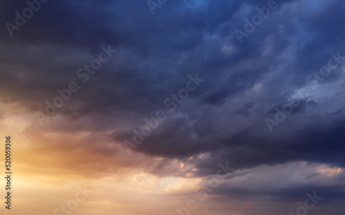 Dramatic sunset sky with dark rainy clouds and bright sunshine. © Артур Ничипоренко