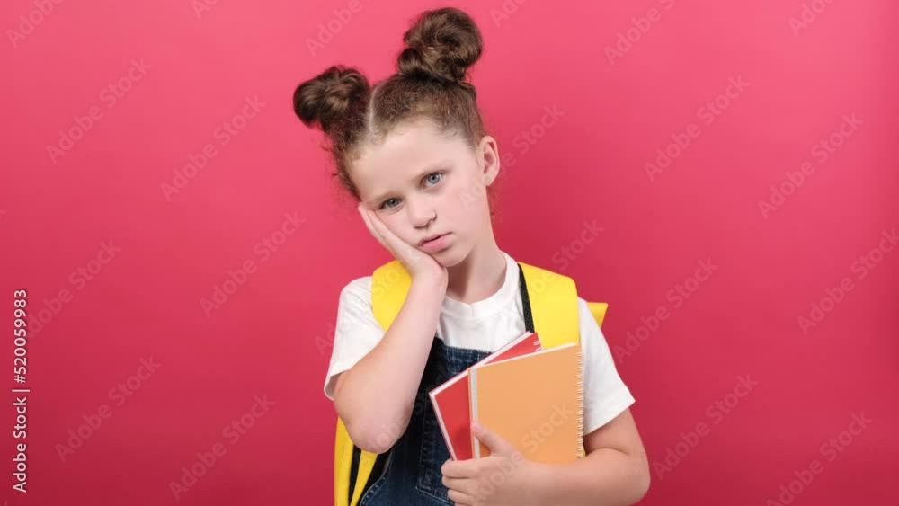 Portrait of sad tired little girl in white tshirt and backpack sleeps