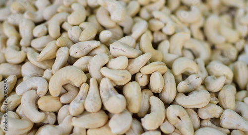 Background of big raw cashews street view, selective focus