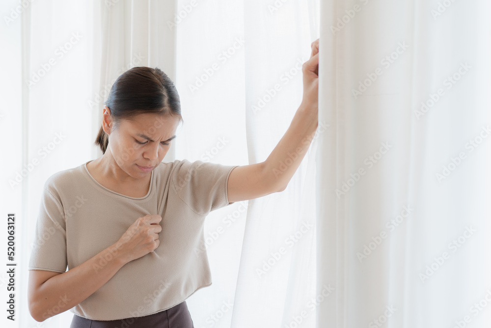 woman looking out window , The women has heart disease and go to hospital urgent. People with heart problem concept woman looking out window , The women has heart disease and go to hospital urgent. People with heart problem concept