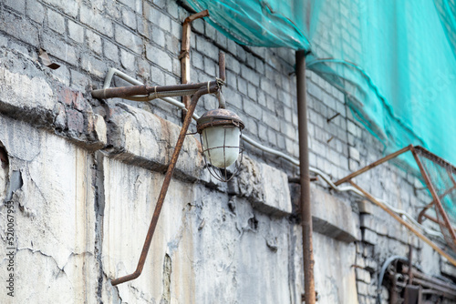 old electric lantern on a brick wall