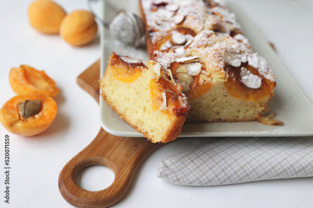 rectangular appetizing homemade apricot pie on a rectangular plate. Cut portion piece close-up rectangular appetizing homemade apricot pie on a rectangular plate. Cut portion piece close-up