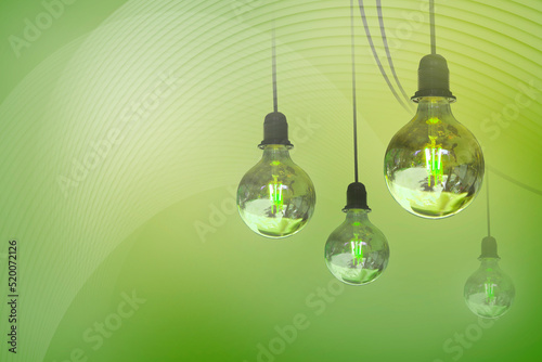 Quadro em tela Light bulbs on a green background as a symbol of alternative green energy