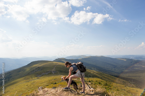 young woman with a dog in the mountains on a hike © Victoriya Bulyha