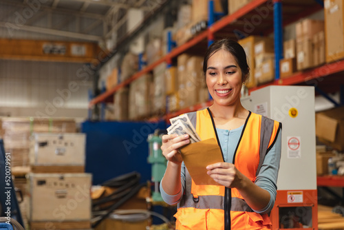 Worker employee recieve salary with working overtime bonus money payday work in factory warehouse photo