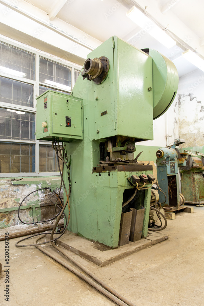 Old soviet hydraulic press in the production hall of an engineering plant Old soviet hydraulic press in the production hall of an engineering plant