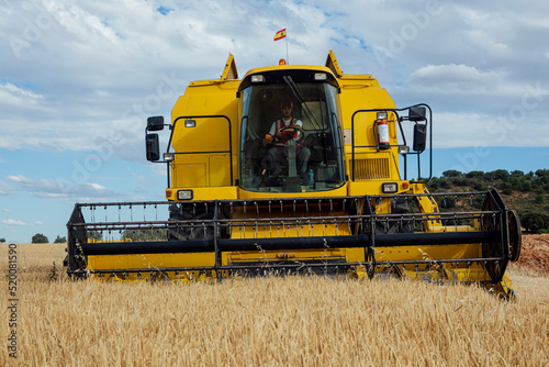Combine harvester in agricultural field photo