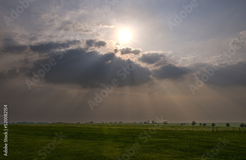 Sun peeping through dark clouds, sun rays, sun shining through clouds, shining above, dramatic sun rays