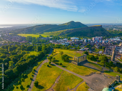 Holyrood Park and Holyrood Palace aerial view from Calton Hill in Edinburgh, Scotland, UK. Old town Edinburgh is a UNESCO World Heritage Site since 1995.  photo