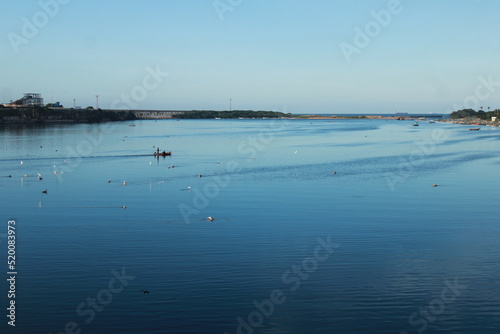 Beautiful view of boat and few birds relaxing in Ennore coast, Chennai.