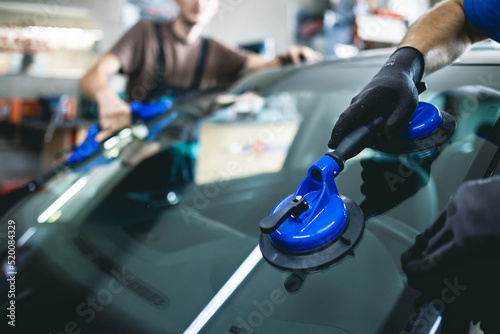 Replacement of car glass in a car service.