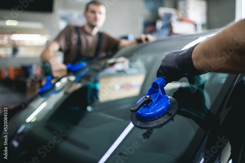 Replacement of car glass in a car service.