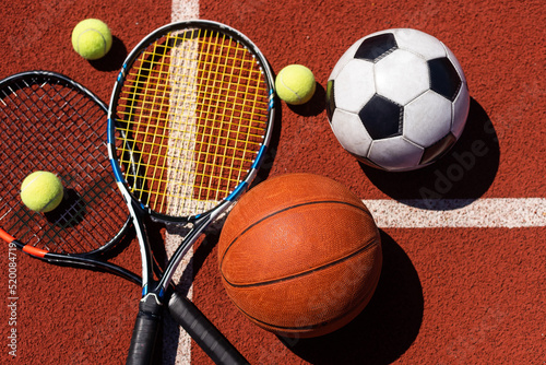 A group of sports equipment on black background including tennis  basketball  and soccer and boxing equipment on a background with copy space