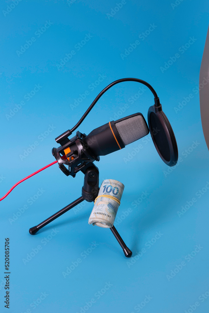 A microphone with a wad of money