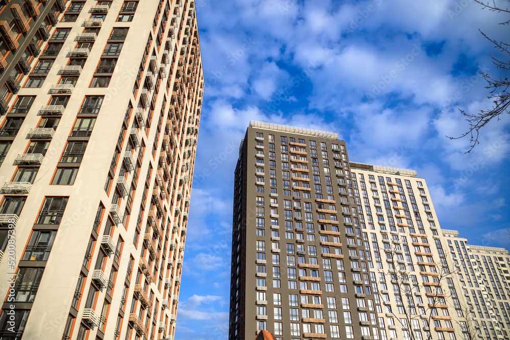 Bottom-up view of the futuristic stone and glass buildings of the Moscow office center. Detailed pictures of exterior urban architecture. Element of architecture