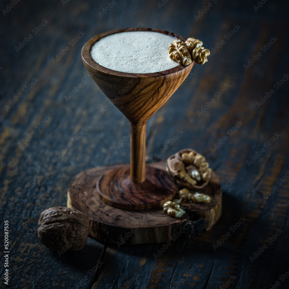 Cocktail martini in wooden glass on wooden background. Cocktail martini in wooden glass on wooden background.