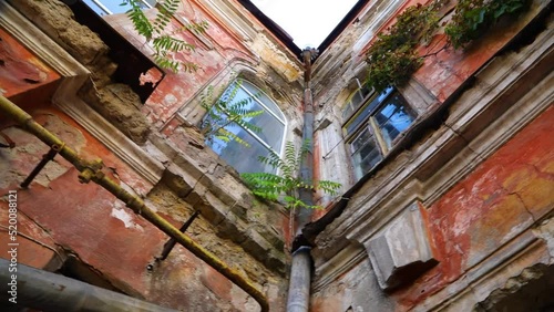 Very old ancient ruined building in the inner yard in street of Odessa, Ukraine. High quality FullHD footage