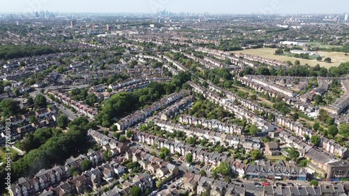 Aerial view Highams Park, a residential neighbourhood surrounded by forest and green parks on the outskirts of London. upmarket residential housings, and semi detached houses in the morning summer sun photo