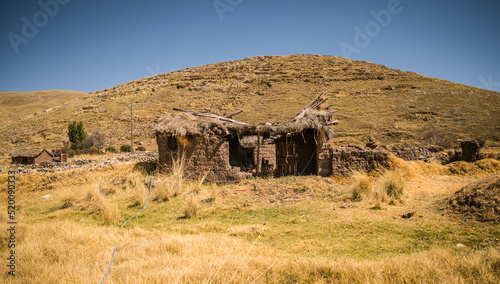 abandoned house near mountains and yellow landscape in yanaoca, cusco, peru