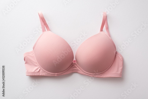 Breast cancer awareness concept. Top view photo of pink brassiere on isolated white background photo