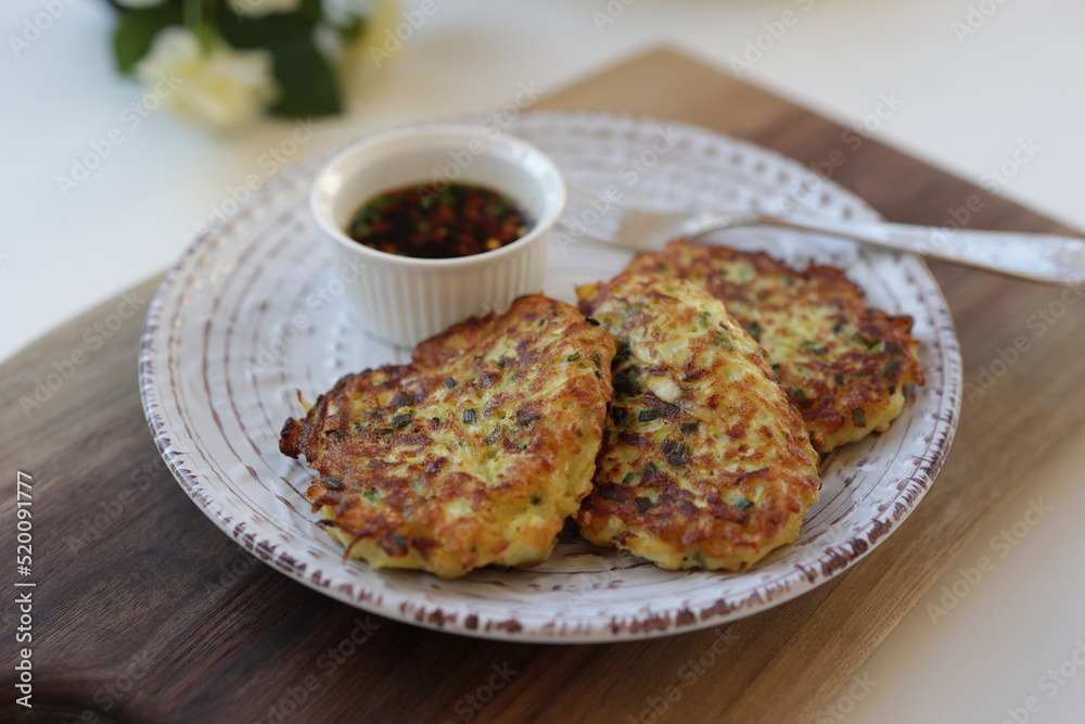 Zucchini fritters, vegetarian zucchini fritters, served with soy dipping sauce.