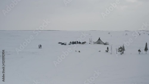 A camp of yurts of a small northern people in the Arctic. Aerial view of the winter landscape of the yurt camp with reindeer photo