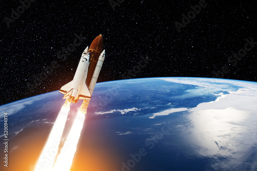 Fototapeta Naklejka Na Ścianę i Meble -  Spaceship lift off. Space shuttle with smoke and blast takes off into the starry sky. Rocket starts into space. Concept. Elements of this image furnished by NASA.