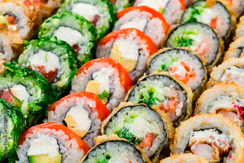 set of different colorful maki sushi rolls sushi texture background