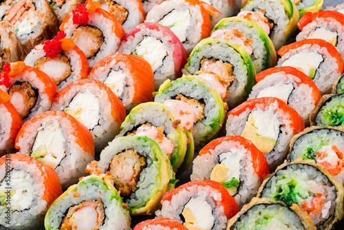 set of different colorful maki sushi rolls sushi texture background