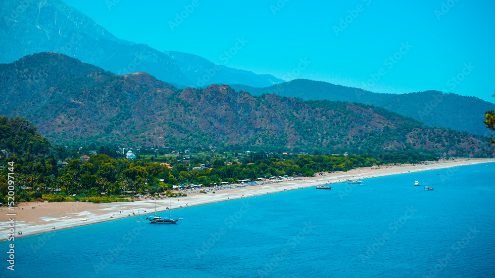 View of Cirali beach and Olimpos (Olympos) mountain in a sunset light. Kemer, Antalya, Mediterranean region, Turkey, Lycia. View of Cirali beach and Olimpos (Olympos) mountain in a sunset light. Kemer, Antalya, Mediterranean region, Turkey, Lycia.