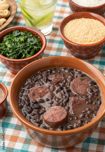 Typical brazilian feijoada with rice, caipirinha, farofa and cracklings