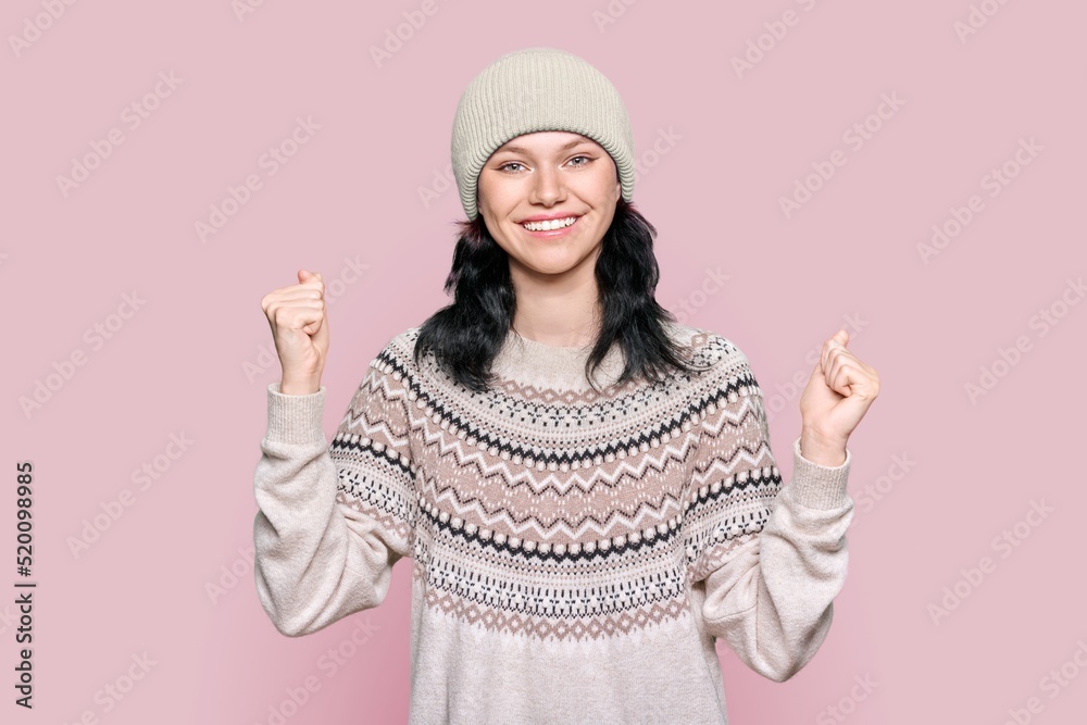 Portrait of happy young woman in sweater hat celebrating winter holidays Portrait of happy young woman in sweater hat celebrating winter holidays