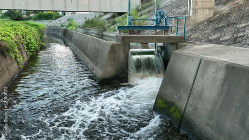 Water flows through gate to canal in slow motion