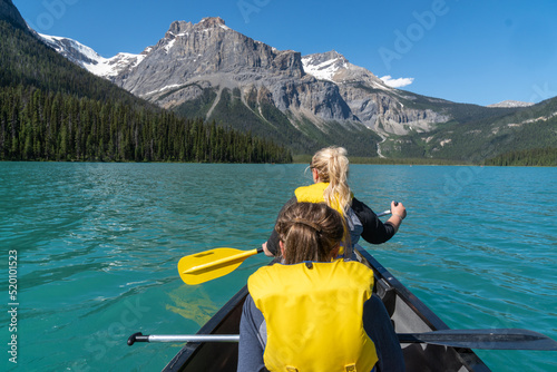 Valokuva Two adult woman paddle on a canoe on Emerald Lake in Yoho National Park in Briti