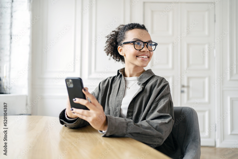 Female student uses phone workplace in coworking space, working with documents Female student uses phone workplace in coworking space, working with documents