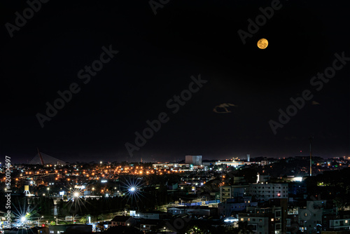 The full moon over the quiet town