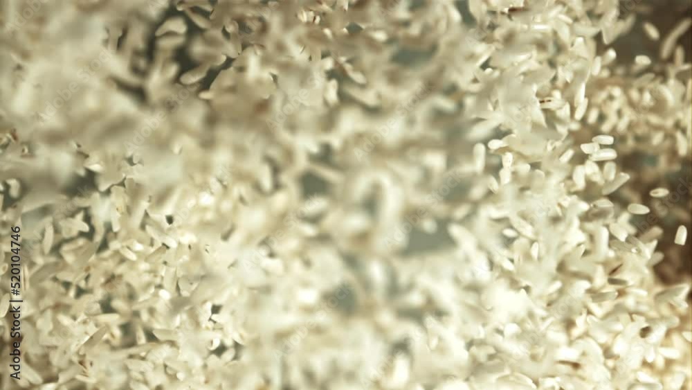 Rice rises up and falls down. Macro background. Top view. Texture of rice. Filmed is slow motion 1000 fps. Rice rises up and falls down. Macro background. Top view. Texture of rice. Filmed is slow motion 1000 fps.