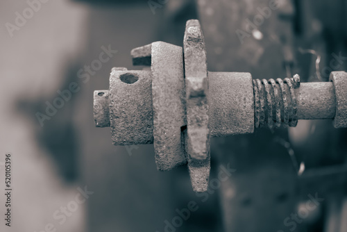 Close up view of rusty metal shaft of old farm equipment