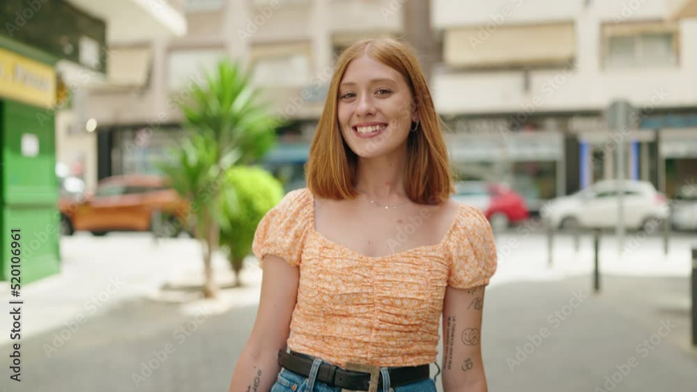 Young redhead woman smiling confident walking at street Young redhead woman smiling confident walking at street