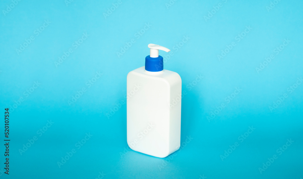 Liquid container for gel, lotion, cream, shampoo, bath foam. Cosmetic plastic bottle with dispenser pump on blue background. Cosmetic packaging mockup with copy space. Liquid container for gel, lotion, cream, shampoo, bath foam. Cosmetic plastic bottle with dispenser pump on blue background. Cosmetic packaging mockup with copy space.