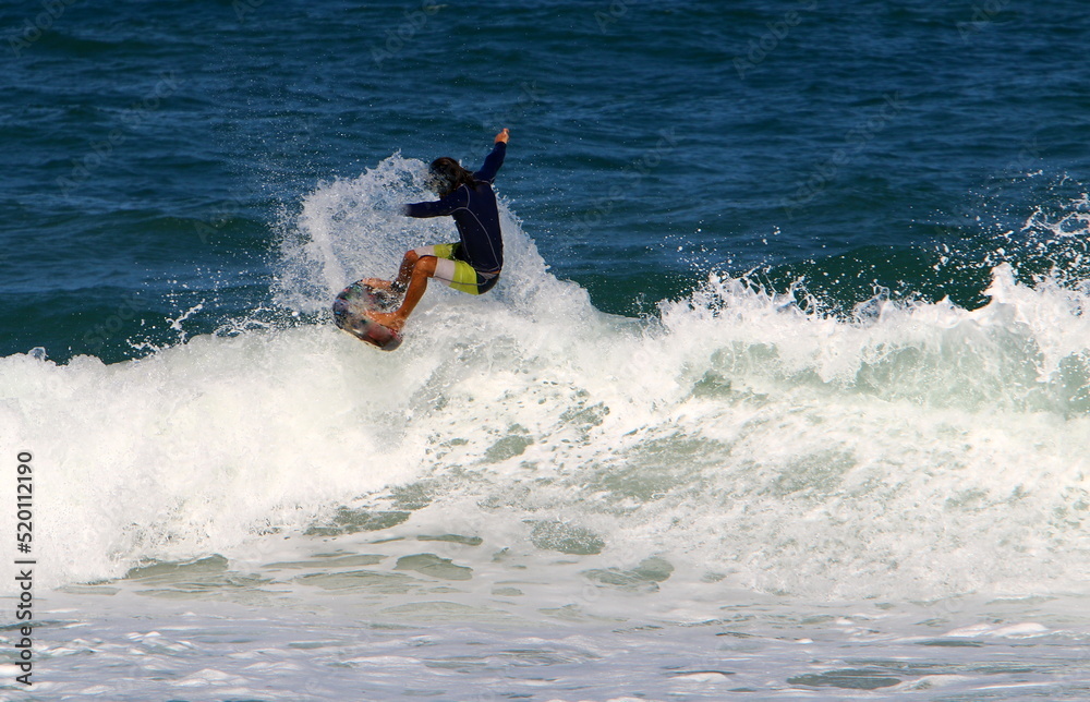 Surfing on high waves in the Mediterranean.