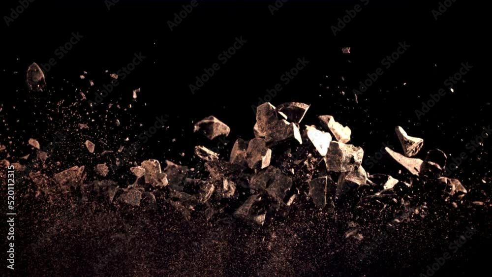 A pile of chocolate pieces rise up and fall down. On a black background. Filmed is slow motion 1000 fps. A pile of chocolate pieces rise up and fall down. On a black background. Filmed is slow motion 1000 fps.
