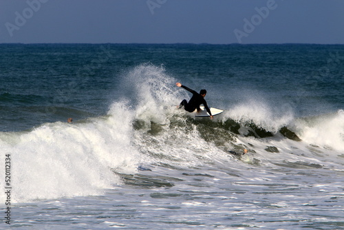 Surfing on high waves in the Mediterranean. © shimon
