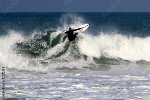 Surfing on high waves in the Mediterranean.