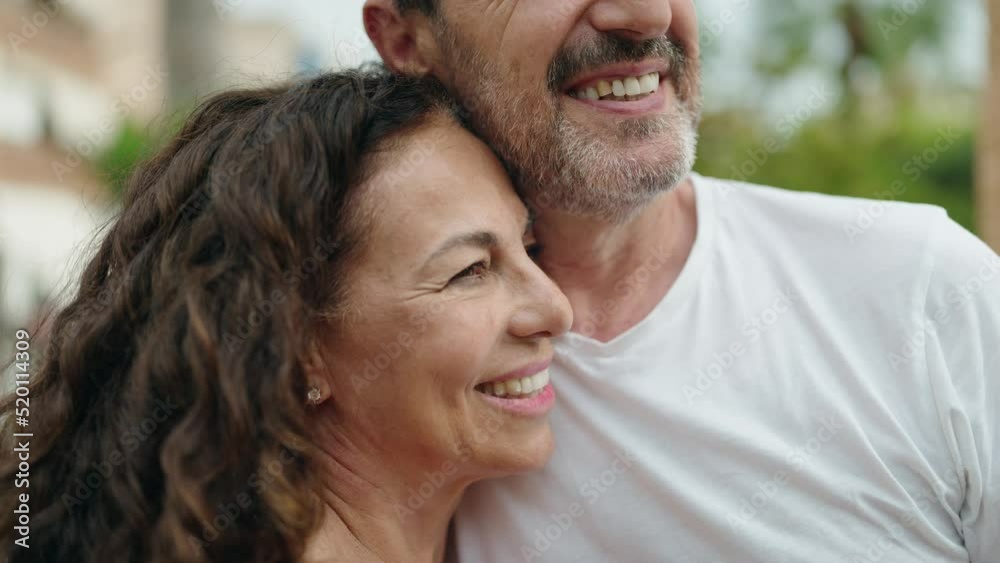 Man and woman couple smiling confident standing together at street Man and woman couple smiling confident standing together at street