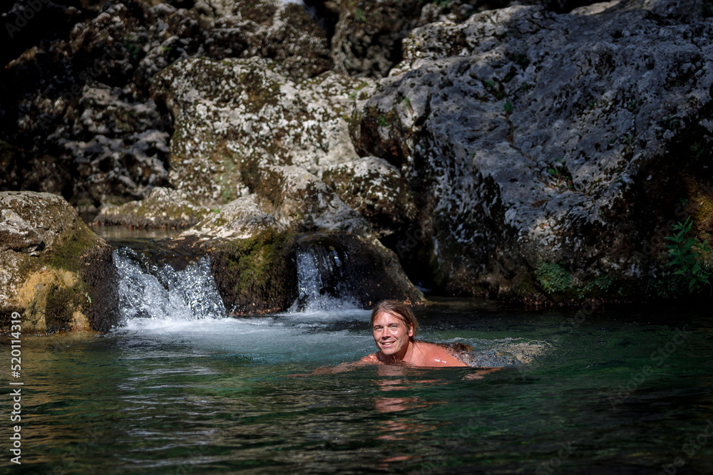 Front View of Wim Hof Method Cold Bathing For A Mid Adult Man in a Cold Wild Water Stream Front View of Wim Hof Method Cold Bathing For A Mid Adult Man in a Cold Wild Water Stream