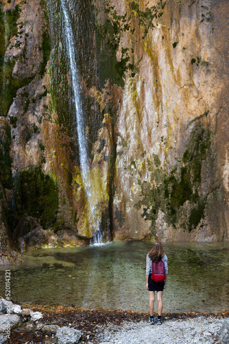 Discovering A Splendid Tiny Tall Waterfall and its lagoon for a Female Red Backpack Hiker