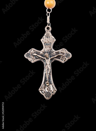 Silver crucifix close-up isolated on black background